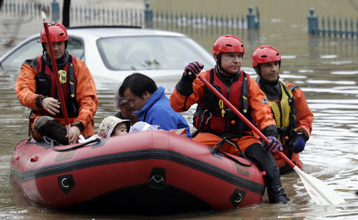 Rescue crews take out residents from a flooded neighborhood Tuesday, Feb. 21, 2017, in San Jose, Calif. Rescuers chest-deep in water steered boats carrying dozens of people, some with babies and pets, from a San Jose neighborhood inundated by water from an overflowing creek Tuesday. (AP Photo/Marcio Jose Sanchez)